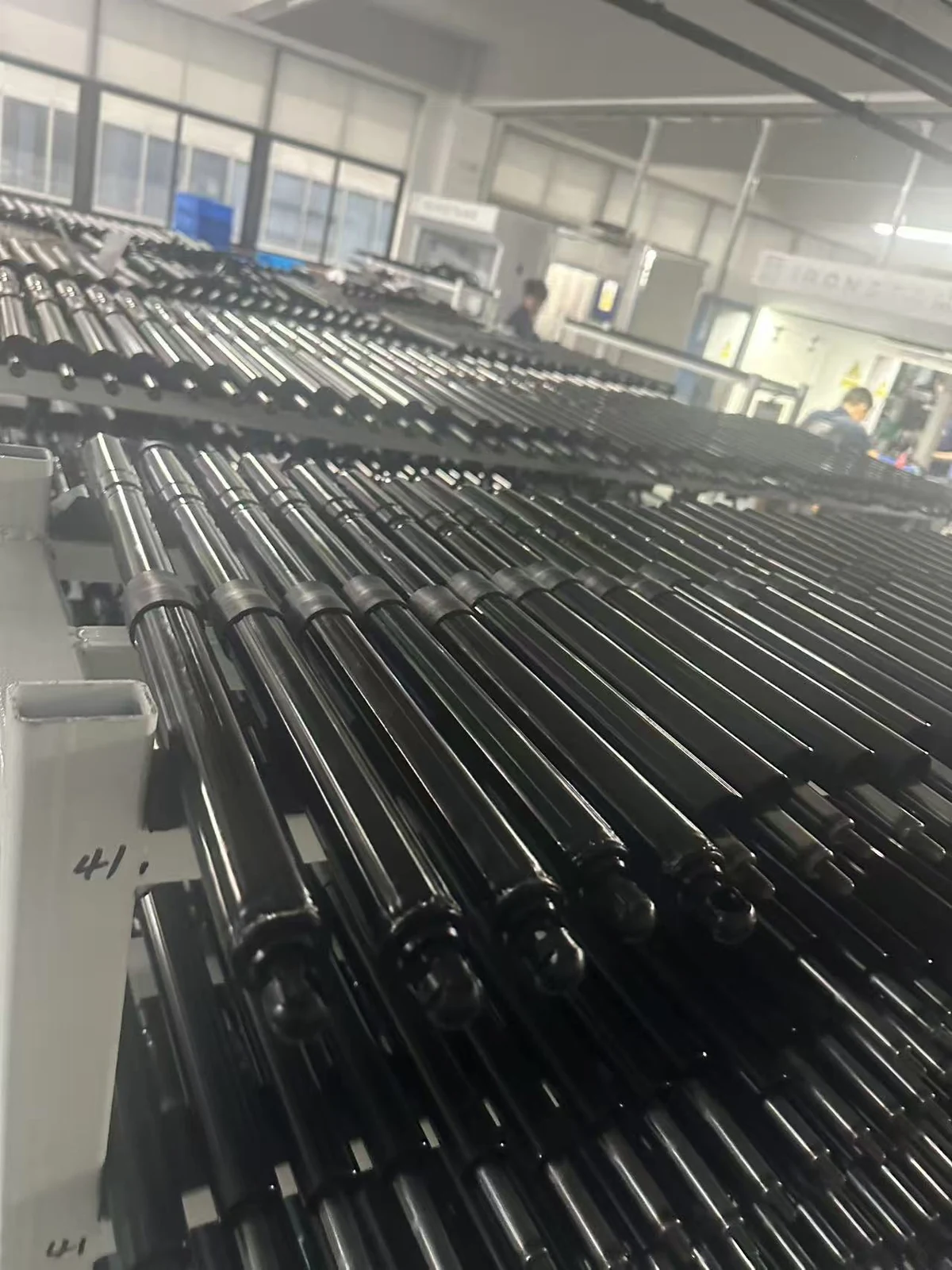 Rows of black support struts on manufacturing racks