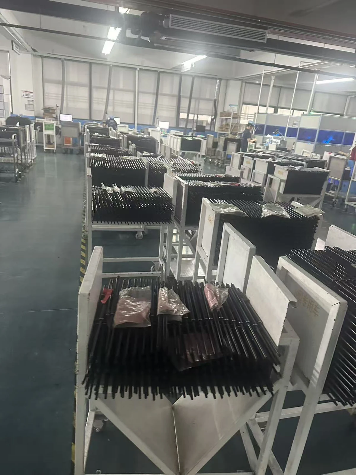 Rows of automotive support struts on workshop racks
