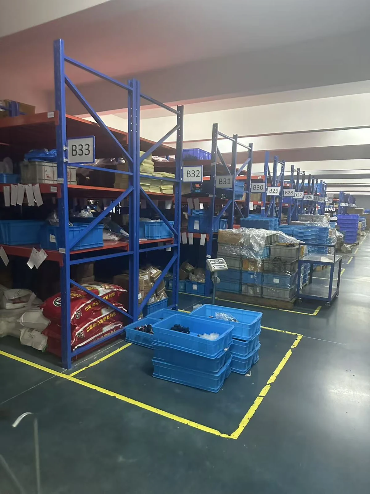 Warehouse shelves and blue parts containers